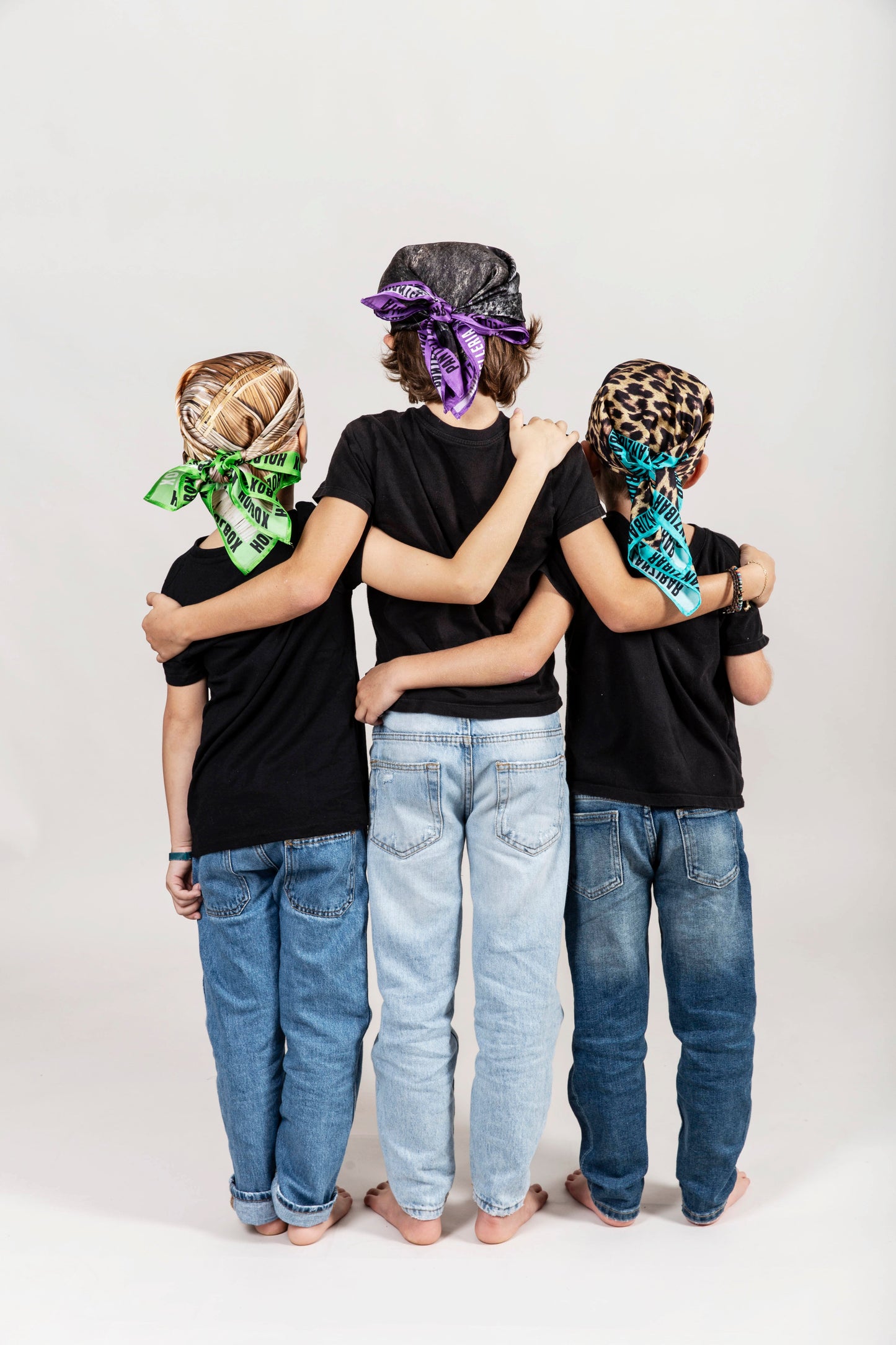 a group of three children standing next to each other